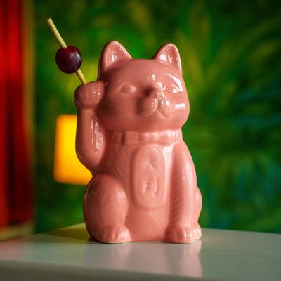 Cat shaped glass with drink.