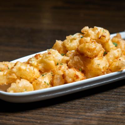 Cheese curds on a long serving tray.