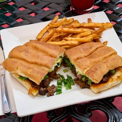 Carnitas torta served with fries.
