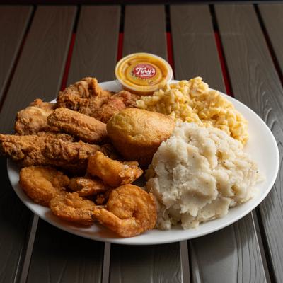 Fried chicken and shrimp served with mashed potatoes, mac and cheese and cornbread.