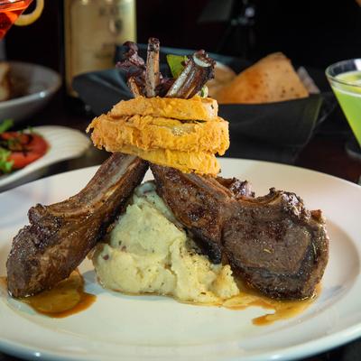 Lamb Chops with onion rings and mashed potatoes.