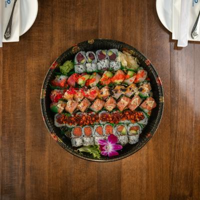 Assorted sushi platter arranged on a large round serving tray.