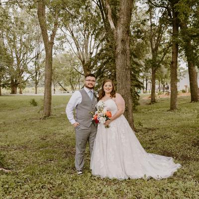 Wedding couple standing underneath the trees at Next Chapter Winery.