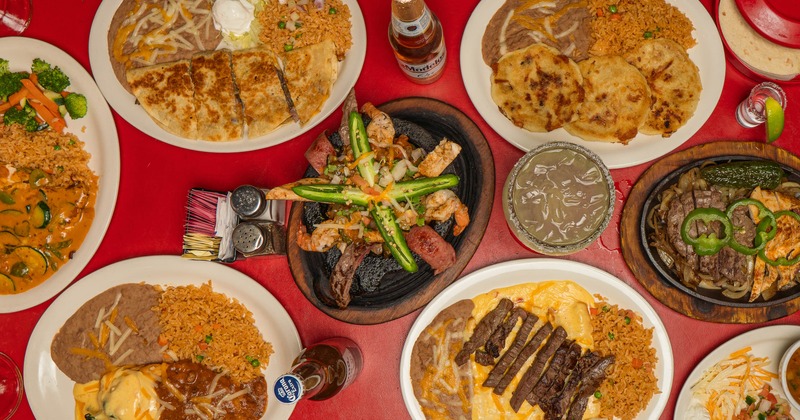 Overhead view of assorted Mexican dishes and drinks