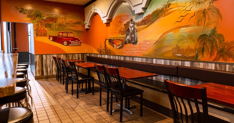 Interior corner, tables, chairs, booths, wall murals