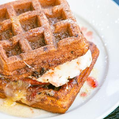 Waffle sandwich, with over medium egg, raspberry habanero jam, bacon, and cheese.