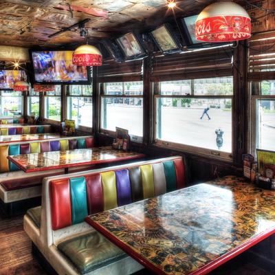 A cozy diner with colorful, striped booths and vintage decor