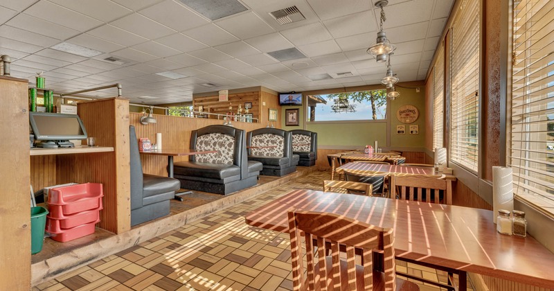 Interior, restaurant booths on the left, chairs and tables
