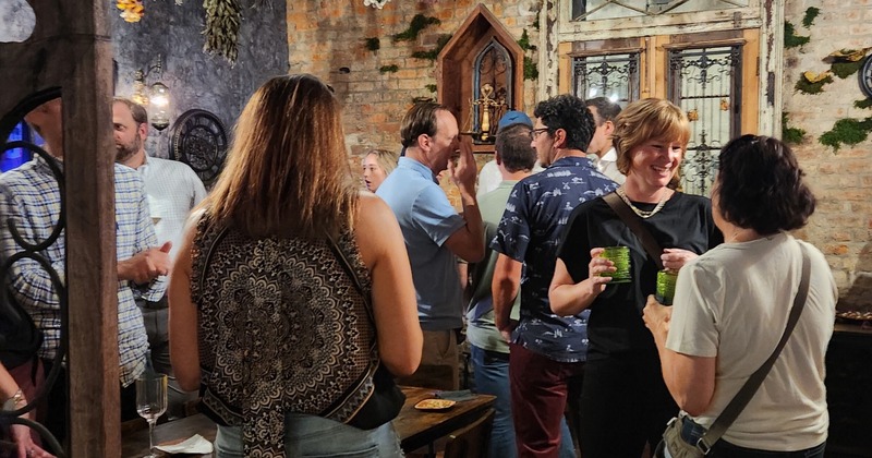 Crowd of guests enjoying drinks and socializing inside