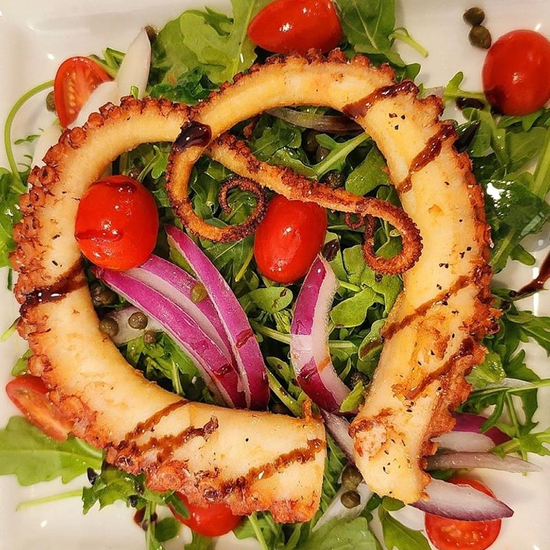 Grilled smoked octopus salad. photo