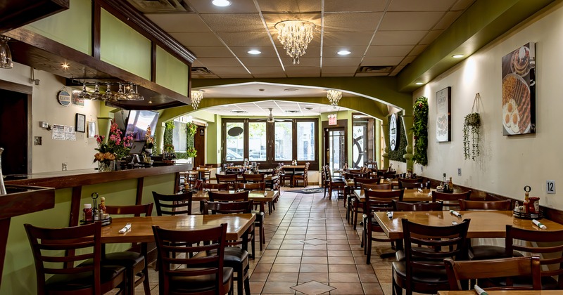 Spacious interior dining area with wooden dining tables and chairs