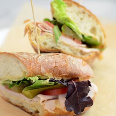 Sandwich features roasted turkey, fresh lettuce, sliced tomatoes and pickles.