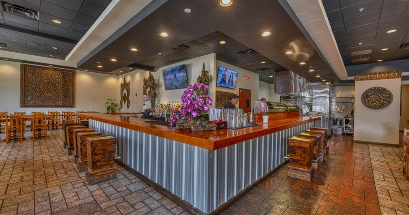 Interior, bar area, wooden top bar with massive wooden stools, TVs on the walls