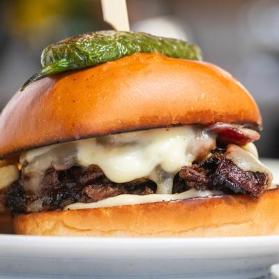 Double cheeseburger topped with a charred jalapeno.