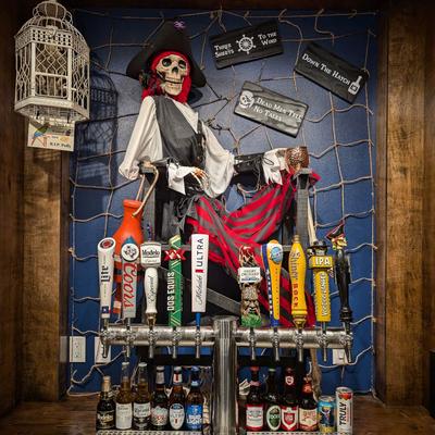 Beer dispensaries and a large pirate skeleton figure on the wall above.