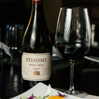 Bottle and glass of red wine.