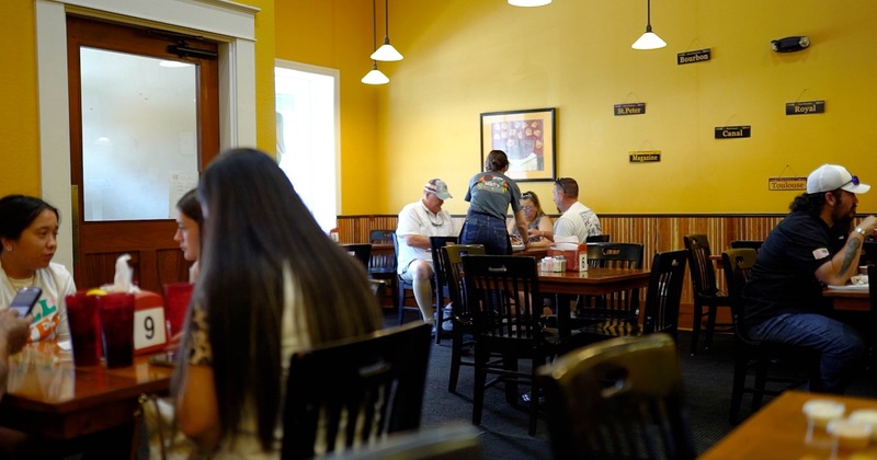 Interior, diner area tables, chairs, people