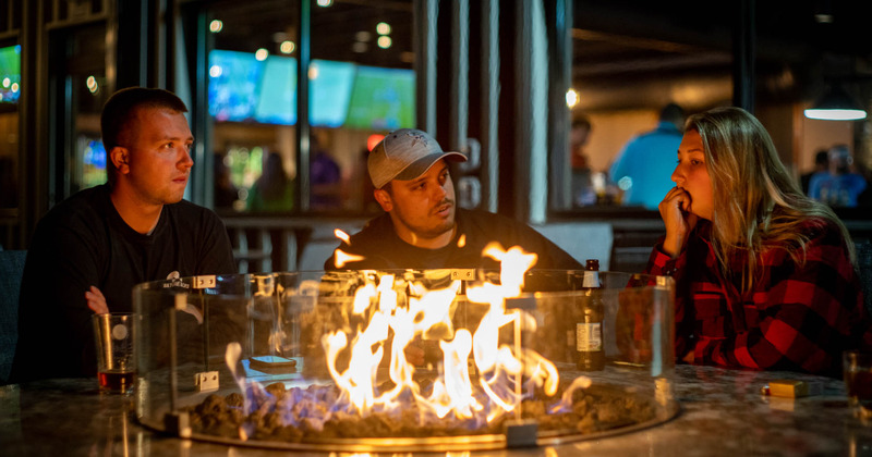 Guests sitting at the fire pit table