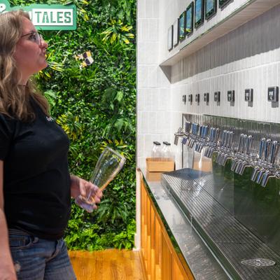 Customer browsing beers from the tap wall.