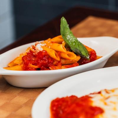 Penne pasta with marinara sauce and fresh basil.