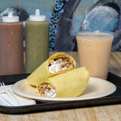 Grilled beef burritos, with fries, sour cream, and cheese.