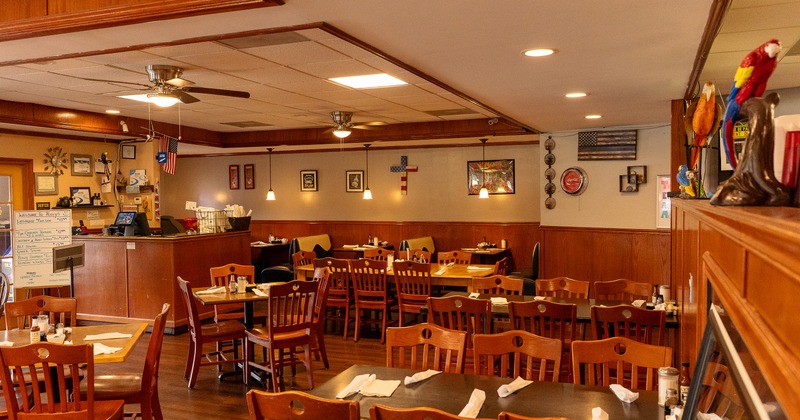 Interior of spacious, cozy, and rustic dining area with set dining tables