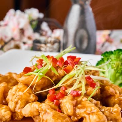 Sweet and Sour Pork topped with shredded scallions and red chilies.