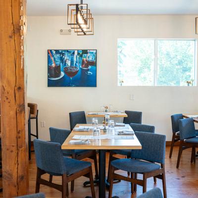 Interior, dining area, wooden top tables with chairs, ready for guests.