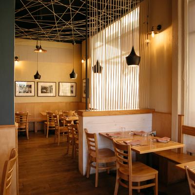 Dining room with wooden furniture and warm lighting.