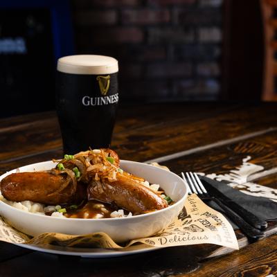 Bangers and Mash, with a glass of Guinness beer.