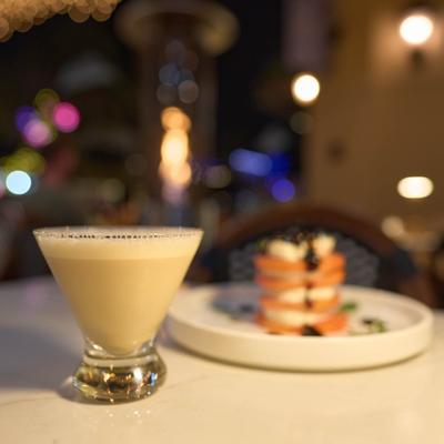 Espresso Martini cocktail paired with a dish of caprese salad.
