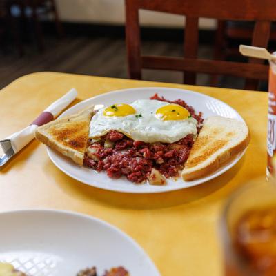 Corned beef hash, with sunny side up eggs and toast.