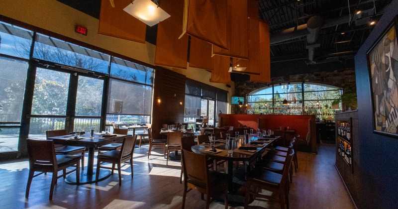 Bright seating area with set tables and large windows