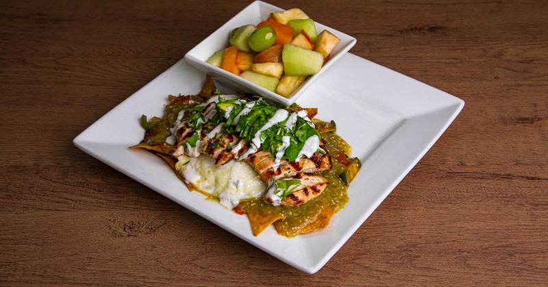 Chilaquiles served with mixed fruit