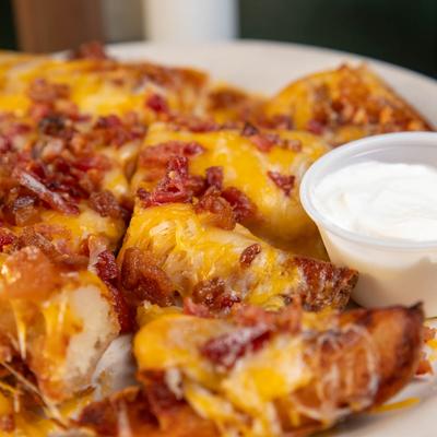 Potato skins served with a dipping sauce.