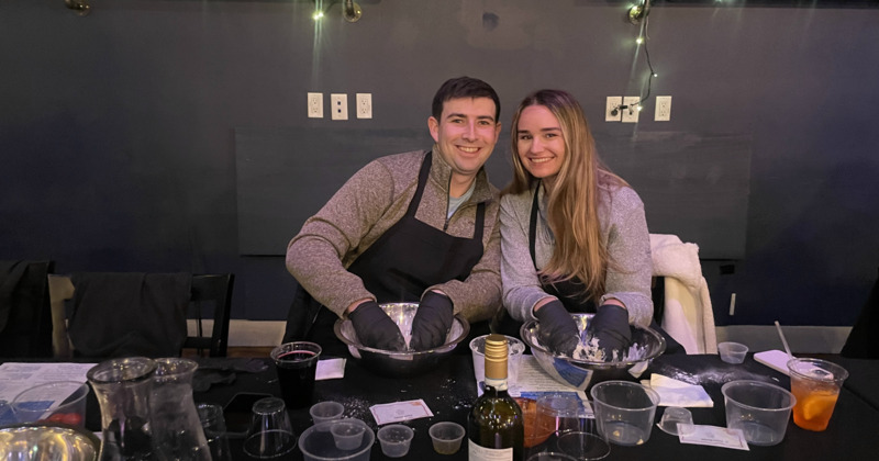 Pasta cooking class, a couple preparing dough at a table