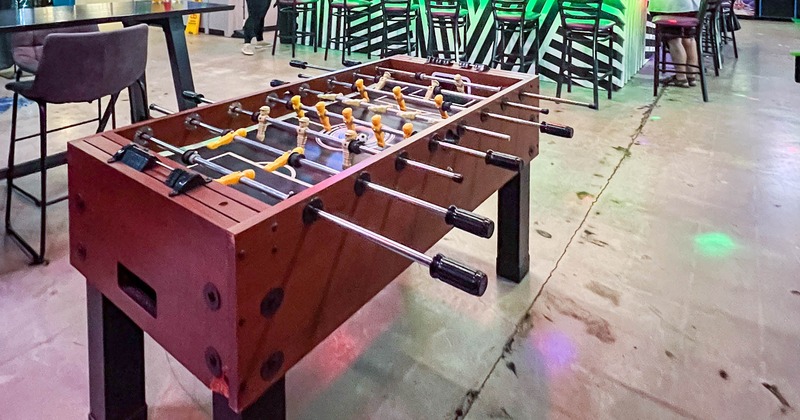 Table football in front, a bar behind