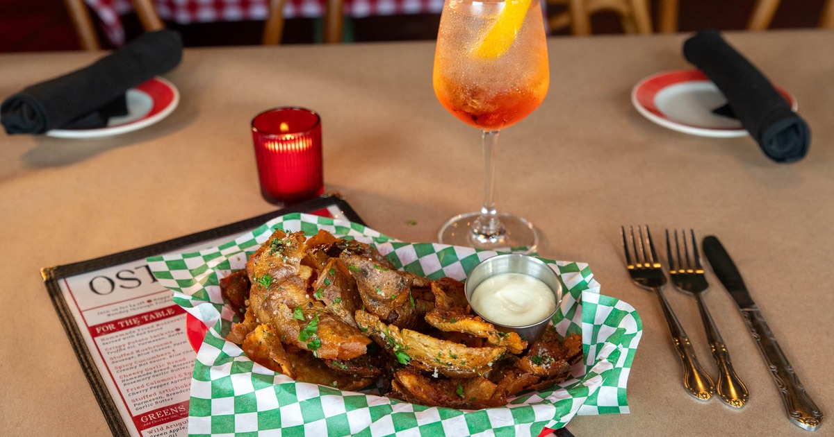 Crispy potato jackets served with dip alongside Aperol spritz