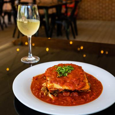 Lasagna plate and a glass of white wine