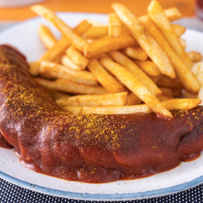 Vegan Currywurst-Pommes - Bratwurst with Curry Sauce and Fries photo