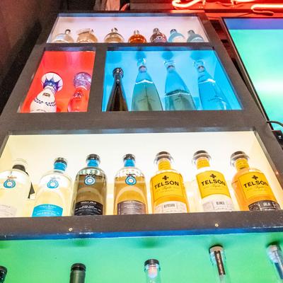 Low angle view of bar shelves with bottles of hard liquor.