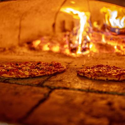 Pizza being baked in an oven.