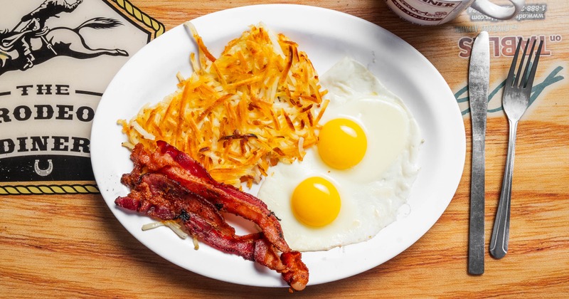Sunny side up eggs with bacon and grits