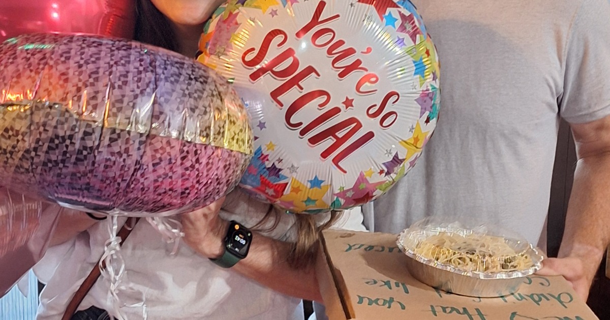 Couple holding balloons celebrating a special event