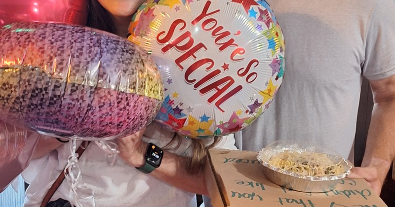 Couple holding balloons celebrating a special event