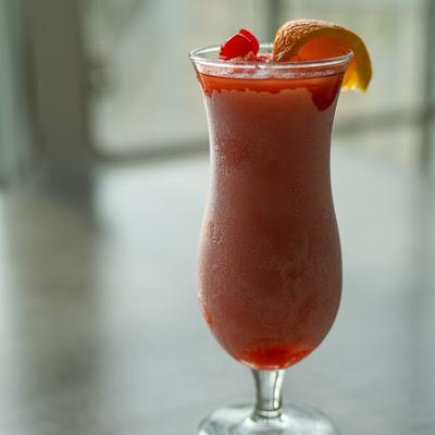 Frozen fruit cocktail with cherry garnish.