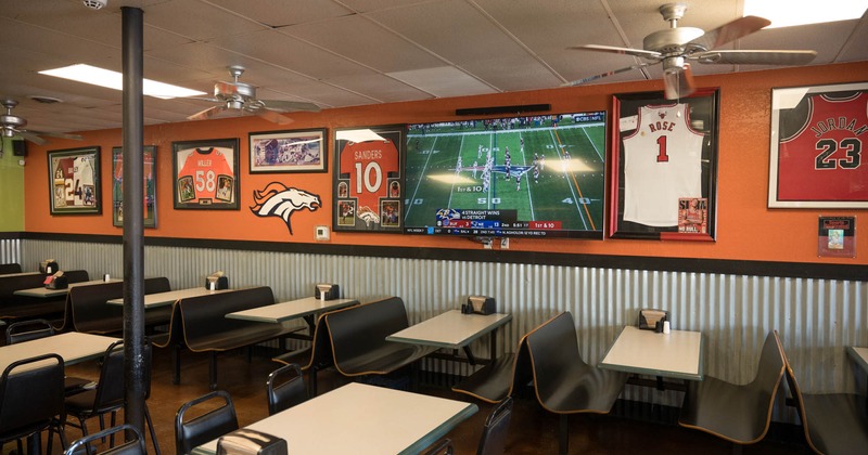 Diner room, tables and chair by the wall with tv