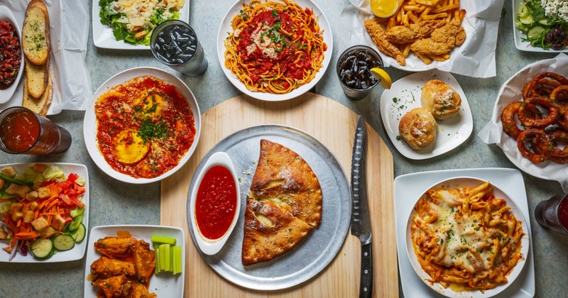 Overhead view of a table spread with a variety of dishes and drinks