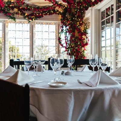 Round dining table, with plates, utensils, napkins, and glasses.