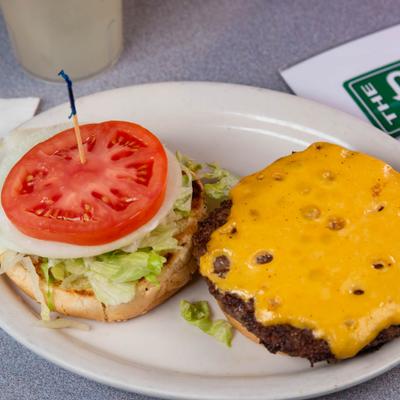 Avenue burger with melted cheese, lettuce, onion and tomato.